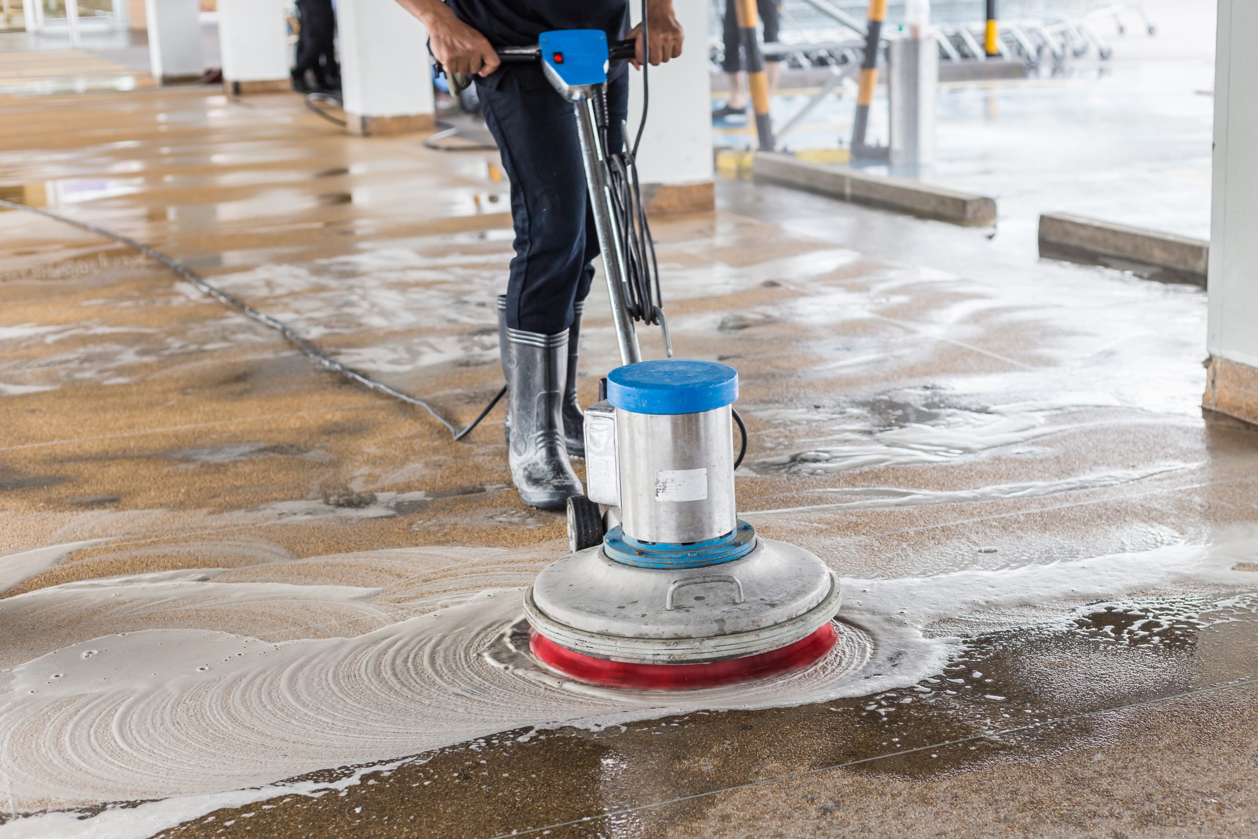 Asian worker cleaning sand wash exterior walkway